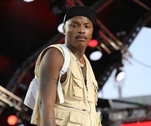 Shebeshxt in superhero outfit at Limpopo children’s party, musician doing push-ups on stage, colourful costume with kids laughing, South African artist viral moment, Bona Magazine