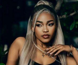 Zee Nxumalo modest white two-piece and hat, singer after backlash over revealing outfit, style evolution celebrity, Bona Magazine