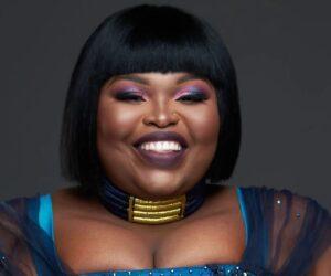 Gogo Maweni holding stacks of money like phone, viral sangoma cash video, South African responses tax jokes, social media reaction humorous, Bona Magazine