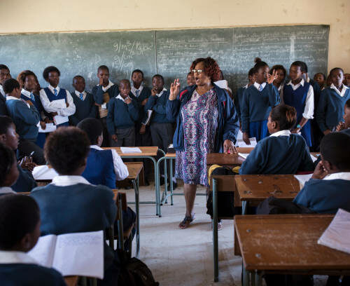 A teacher speaks to students at a class