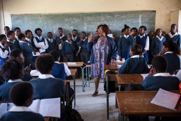 A teacher speaks to students at a class