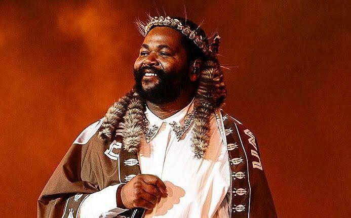 Sjava fashion style, Sjava traditional outfits, Sjava layered clothing look, South African singer Sjava, Sjava trending on X, local celebrity fashion South Africa, Sjava earthy toned outfits, Sjava signature style, Bona Magazine