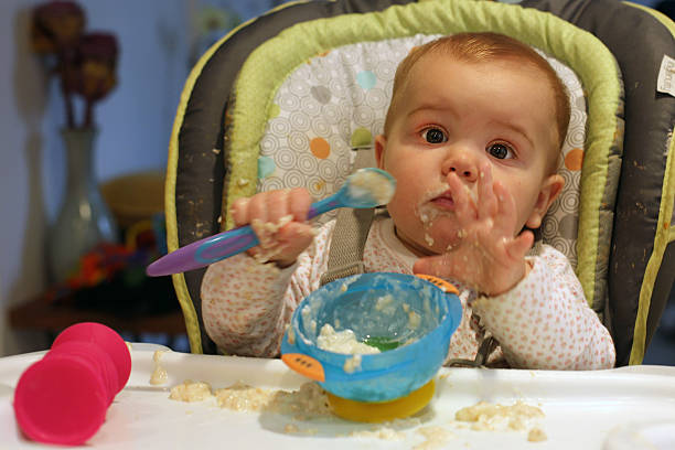 A nine month old baby girl at meal time. Photo Tim Clayton (Photo by Tim Clayton/Corbis via Getty Images)