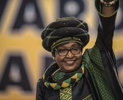 The former wife of the late South African President Nelson Mandela, anti-apartheid campaigner Winnie Mandela waves as she attends the 54th ANC National Conference at the NASREC Expo Centre in Johannesburg on December 16, 2017. Thousands of delegates from South Africa's ANC party gathered on December 16, 2017 for a five-day meeting to elect their new leader in a divisive race seen as a pivotal moment in the country's post-apartheid history. he winner will be well placed to be the next president, but the ANC has lost much popularity since Nelson Mandela led it to power in the euphoric 1994 election that marked the end of white-minority rule. / AFP PHOTO / MUJAHID SAFODIEN (Photo credit should read MUJAHID SAFODIEN/AFP via Getty Images)