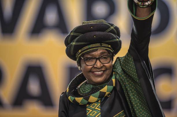 The former wife of the late South African President Nelson Mandela, anti-apartheid campaigner Winnie Mandela waves as she attends the 54th ANC National Conference at the NASREC Expo Centre in Johannesburg on December 16, 2017. Thousands of delegates from South Africa's ANC party gathered on December 16, 2017 for a five-day meeting to elect their new leader in a divisive race seen as a pivotal moment in the country's post-apartheid history. he winner will be well placed to be the next president, but the ANC has lost much popularity since Nelson Mandela led it to power in the euphoric 1994 election that marked the end of white-minority rule. / AFP PHOTO / MUJAHID SAFODIEN (Photo credit should read MUJAHID SAFODIEN/AFP via Getty Images)