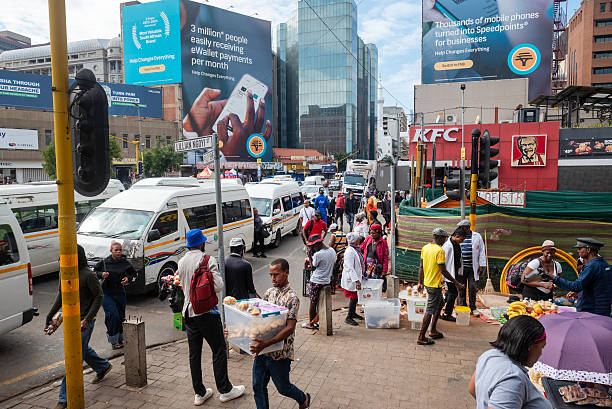 Caption Traffic near street vendors in the central business district in Johannesburg, South Africa, on Wednesday, Feb. 18, 2026. South Africa's unemployment rate dropped to the lowest level in more than five years in the fourth quarter, as the community and social services and construction sectors added workers. Photographer: Leon Sadiki/Bloomberg via Getty Images Description File URL: