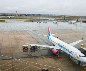 Airport ground staff attend the South African FlySafair low-cost airline Boeing 737-85P aircraft, while it is parked on the tarmac at OR Tambo International Airport in Ekurhuleni on March 12, 2026. Africa is feeling the impact of rising oil prices and threats to shipping, as the continent again suffers from events largely beyond its control. Pump prices in Nigeria were up around 14 percent this week. (Photo by Phill Magakoe / AFP via Getty Images)