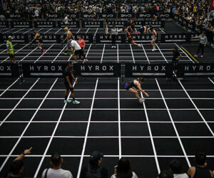 Participants compete in the "burpee broad jumps" event during the Hyrox fitness