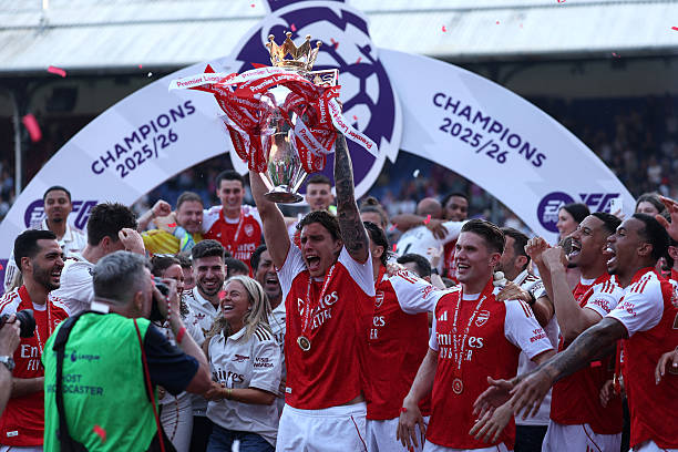 Arsenal's Italian defender #33 Riccardo Calafiori lifts the Premier League trophy at a presentation ceremony on the pitch after the English Premier League football match between Crystal Palace and Arsenal at Selhurst Park in south London on May 24, 2026. Arsenal are English league champions for the first time since 2004, winning the league by seven points. (Photo by Adrian Dennis / AFP via Getty Images) / RESTRICTED TO EDITORIAL USE. No use with unauthorized audio, video, data, fixture lists, club/league logos or 'live' services. Online in-match use limited to 120 images. An additional 40 images may be used in extra time. No video emulation. Social media in-match use limited to 120 images. An additional 40 images may be used in extra time. No use in betting publications, games or single club/league/player publications. /