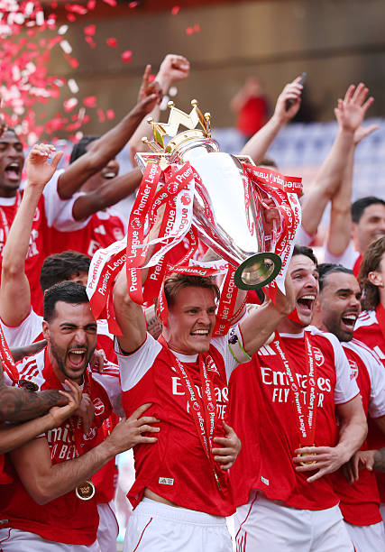 LONDON, ENGLAND - MAY 24: Martin Odegaard of Arsenal lifts the Premier League trophy as the team celebrate becoming champions after the Premier League match between Crystal Palace and Arsenal at Selhurst Park on May 24, 2026 in London, England. (Photo by Catherine Ivill - AMA/Getty Images)
