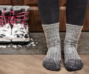 Frozen Feet and Wet Socks due Bad Waterproof Snow Boots. Cold Feet in Child in Winter.