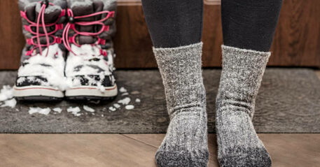 Frozen Feet and Wet Socks due Bad Waterproof Snow Boots. Cold Feet in Child in Winter.