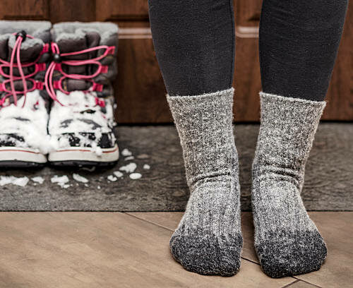 Frozen Feet and Wet Socks due Bad Waterproof Snow Boots. Cold Feet in Child in Winter.