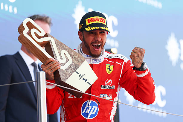 BARCELONA, SPAIN - JUNE 14: Race winner Lewis Hamilton of Great Britain and Scuderia Ferrari celebrates on the podium with his trophy during the F1 Grand Prix of Barcelona-Catalunya at Circuit de Barcelona-Catalunya on June 14, 2026 in Barcelona, Spain. (Photo by Clive Mason/Getty Images)
