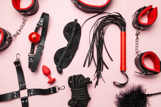 Set of erotic toys for BDSM. The game of sexual slavery with a whip, gag and leather blindfold. Intimate sex games